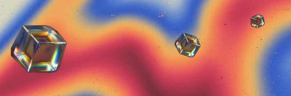 Three glass cubes on a field of orange, blue, and red